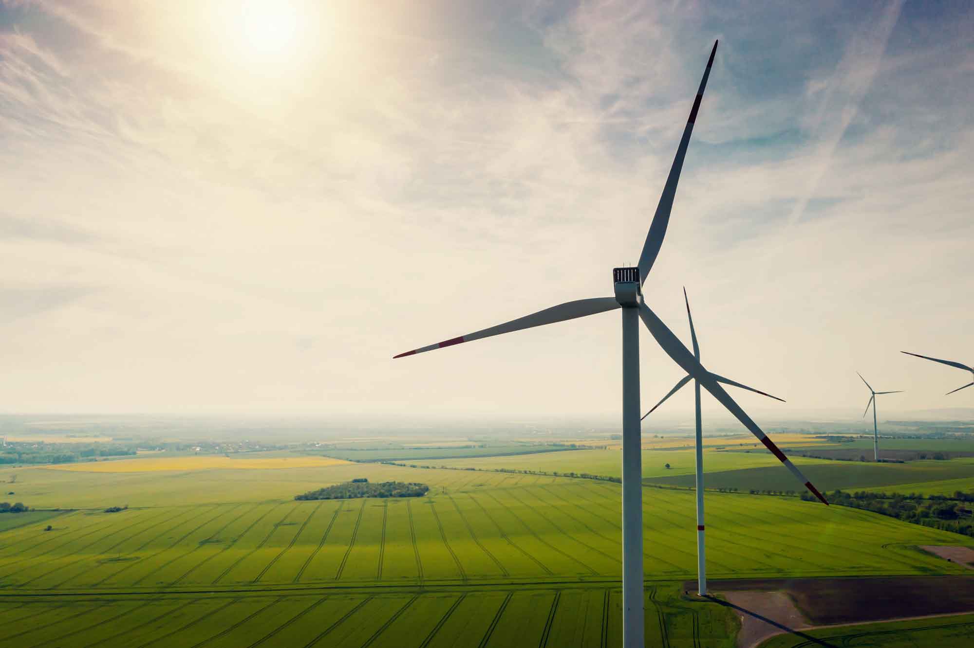 Aerial view of wind turbines and agriculture field