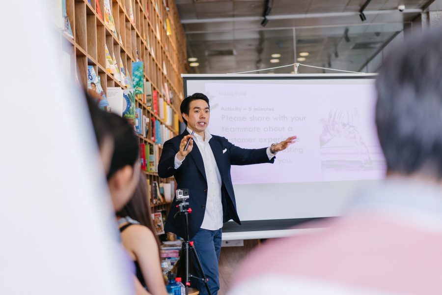 A man presenting to a group of attentive individuals