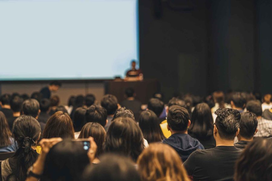 People Attending Seminar In Convention Center