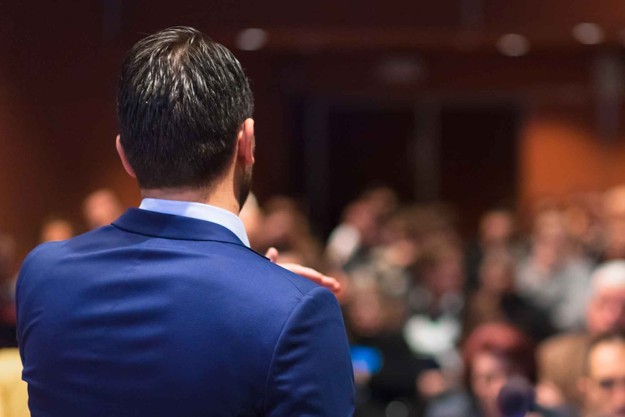 Rear view of speaker giving a talk on corporate Business Conference