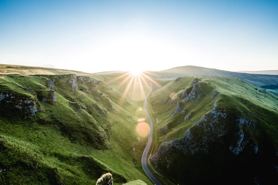 Sunlit winding road through picturesque mountains