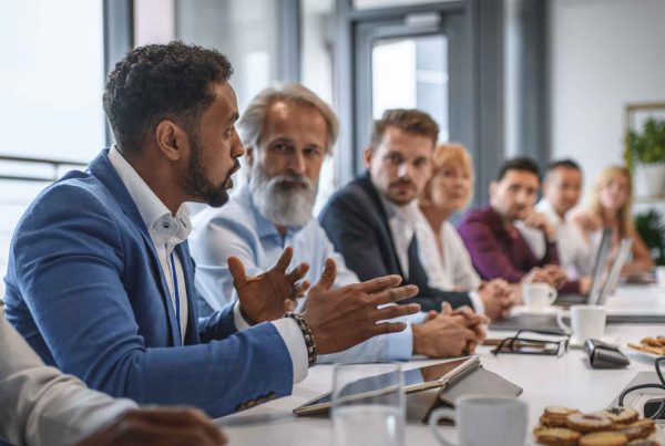 businessman expressing opinions to a team of colleagues in conference room