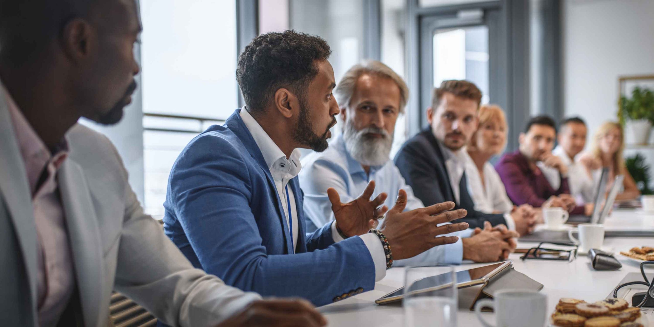 businessman expressing opinions to a team of colleagues in conference room