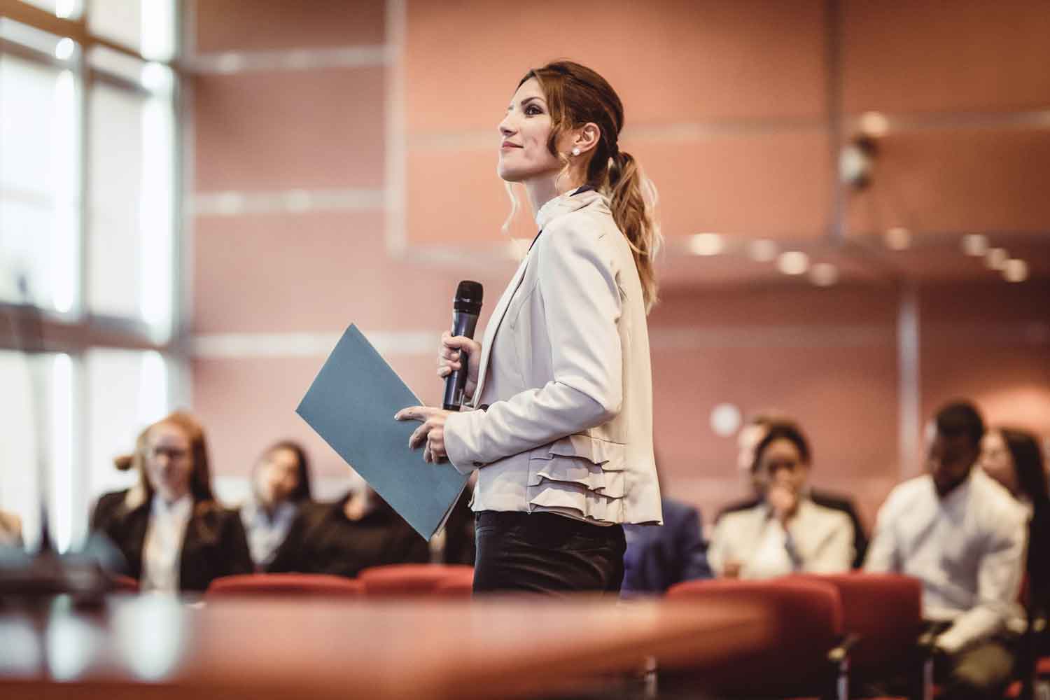 People Listening to the Speaker at a Conference