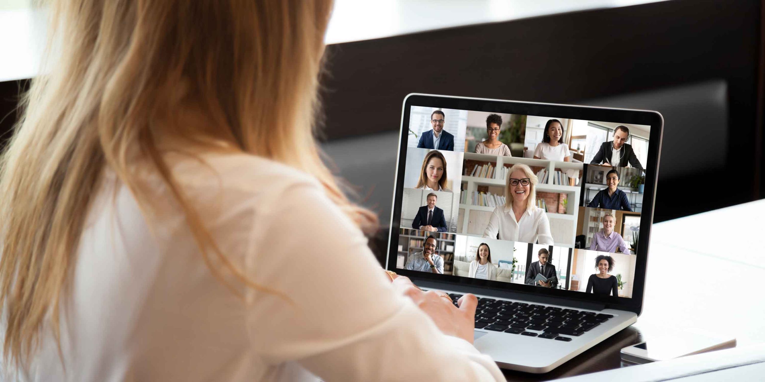View over businesswoman shoulder during group video call