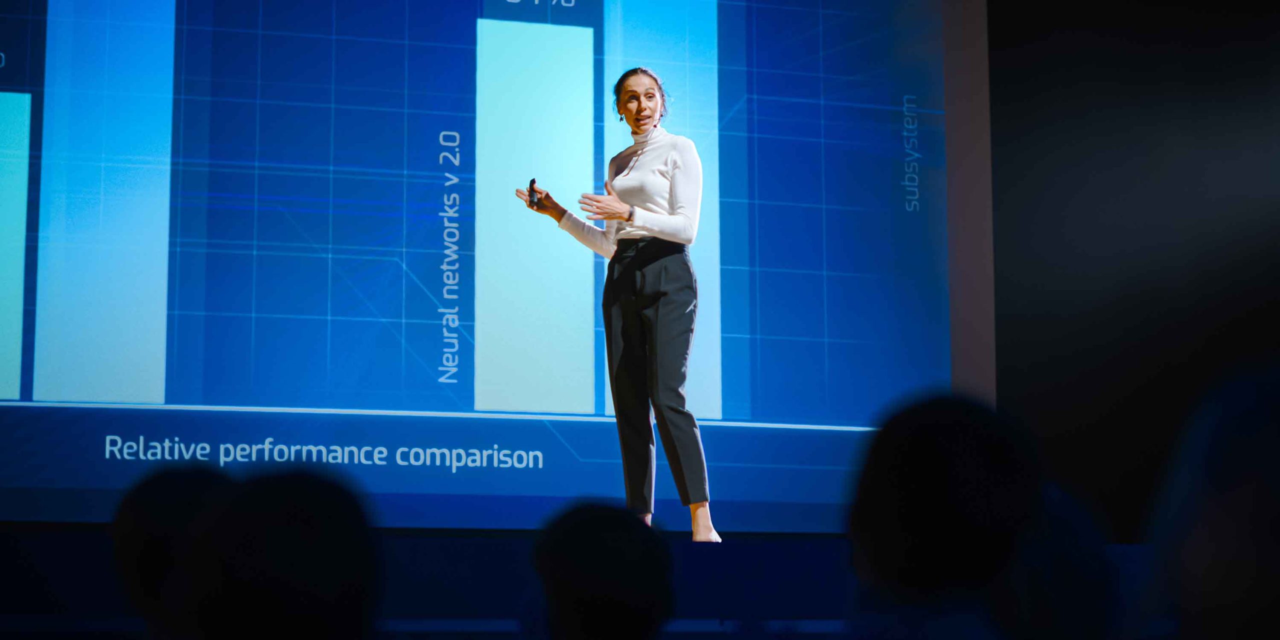 Female speaker presents on stage