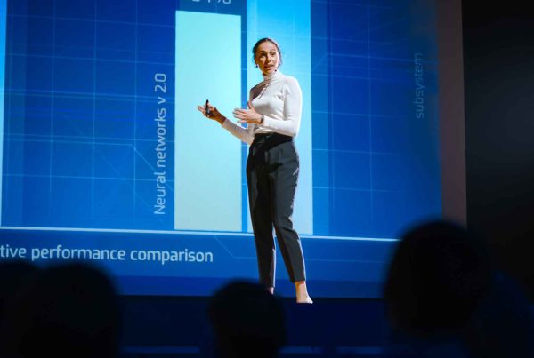 Female speaker presents on stage