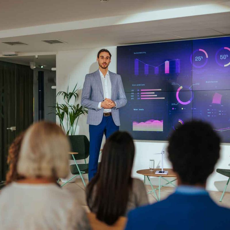 A male lecturer is presenting in a corporate convention