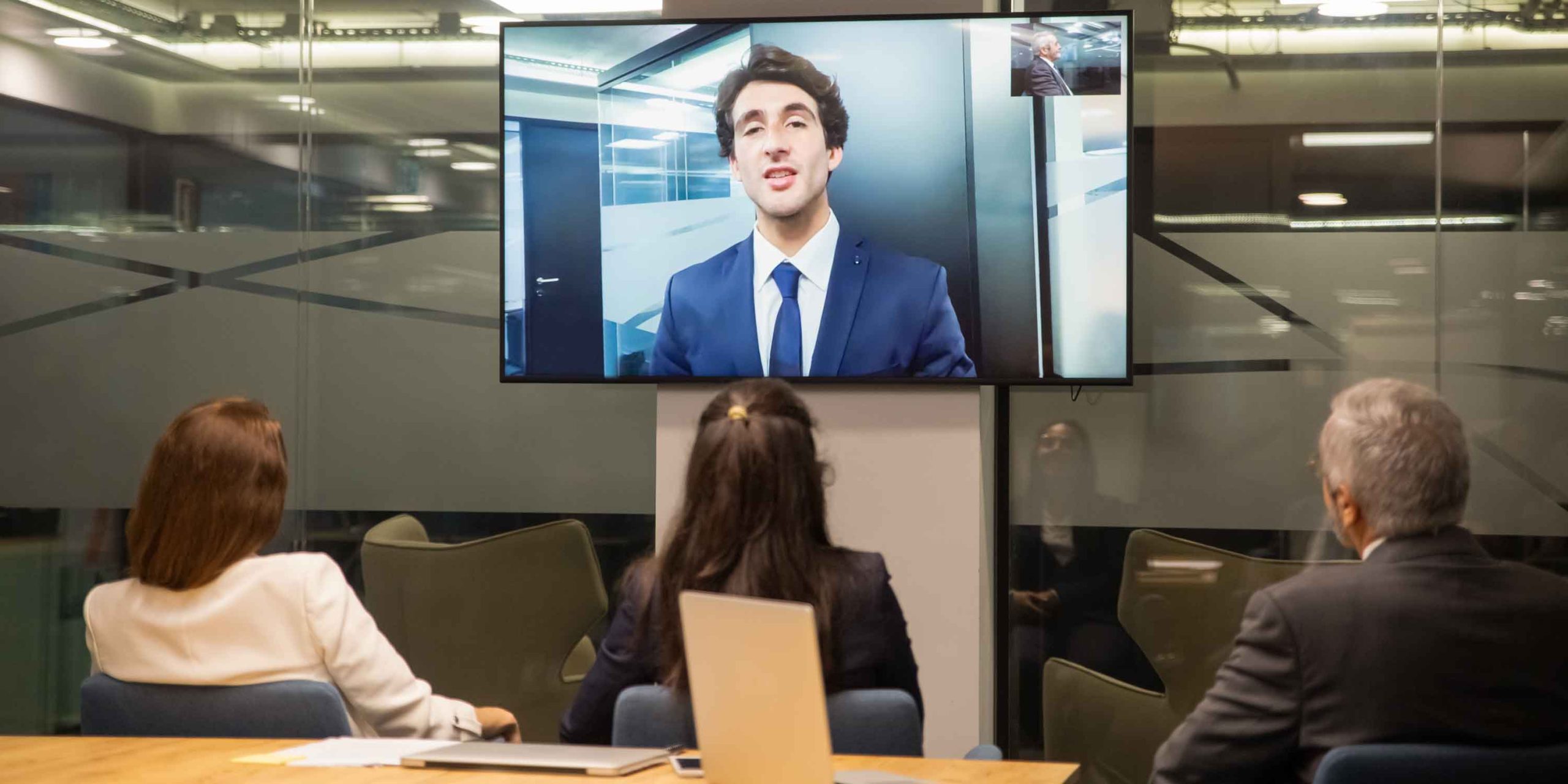 group of people listening to businessman during video conference
