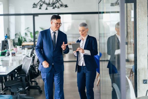 Business people walking and talking discussing ideas in the office