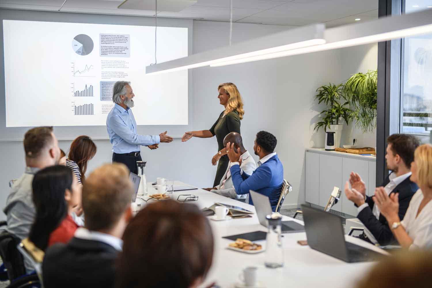 CEO Introducing Female Guest Speaker at Executive Meeting