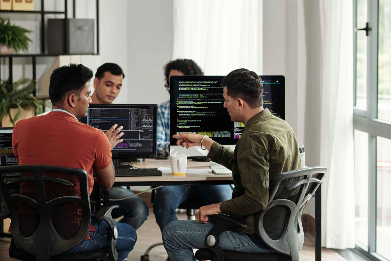 group of software developers reviewing programming