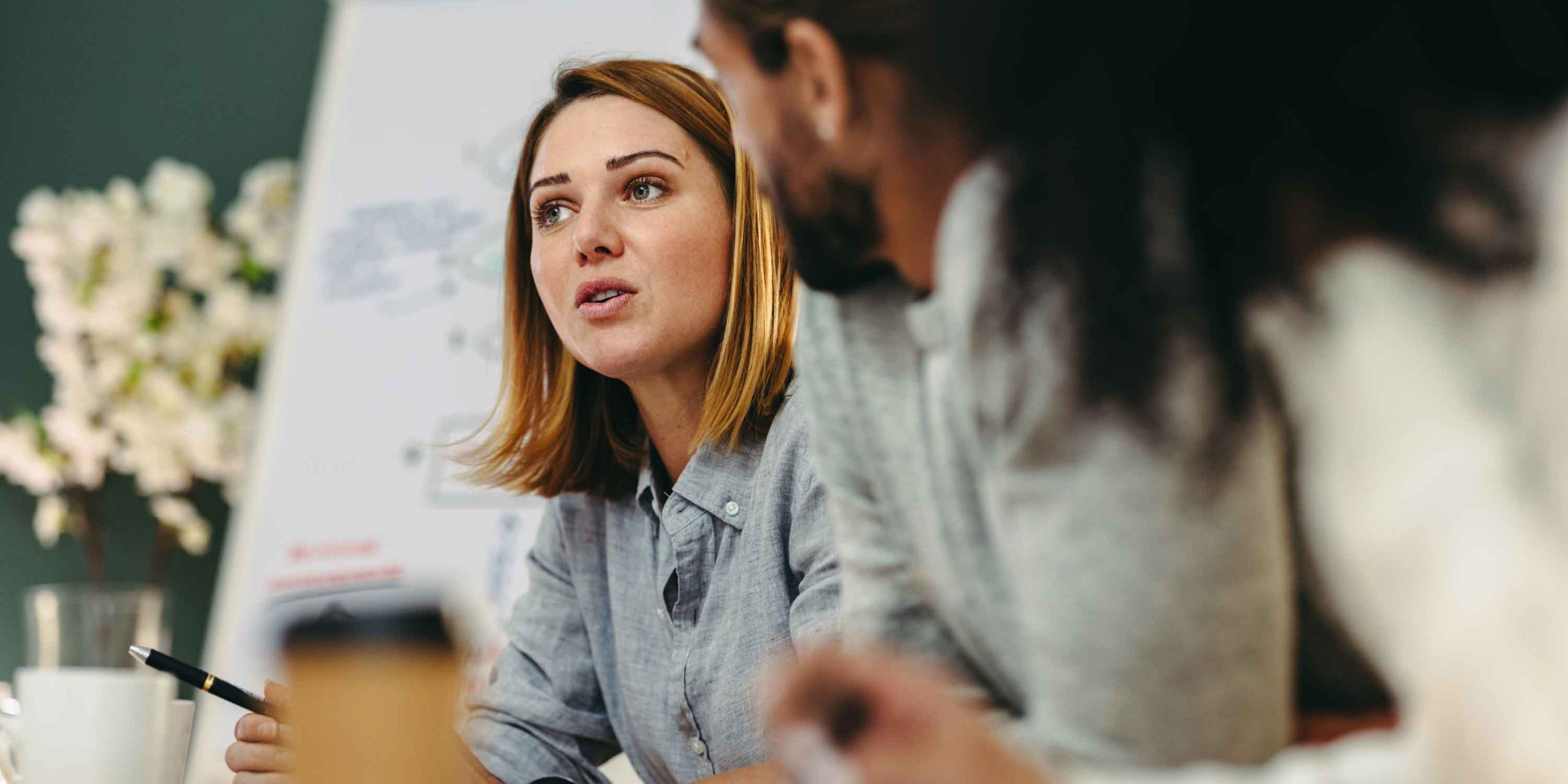 Young businesswoman having a discussion with her colleagues in a boardroom