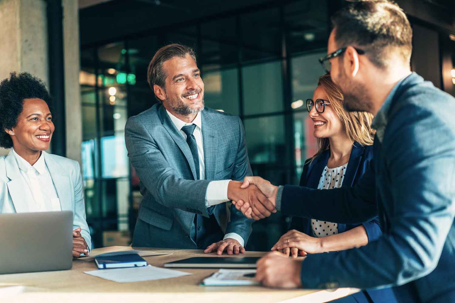 Group of people in business meeting shaking hands