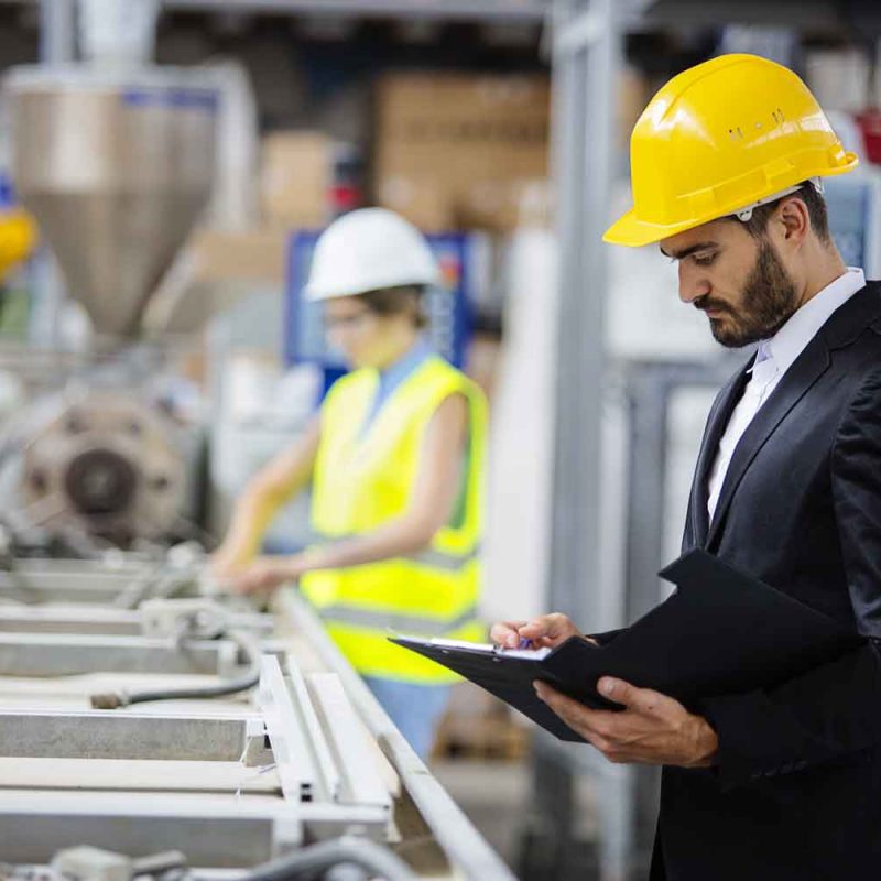 Young quality inspector checking production line