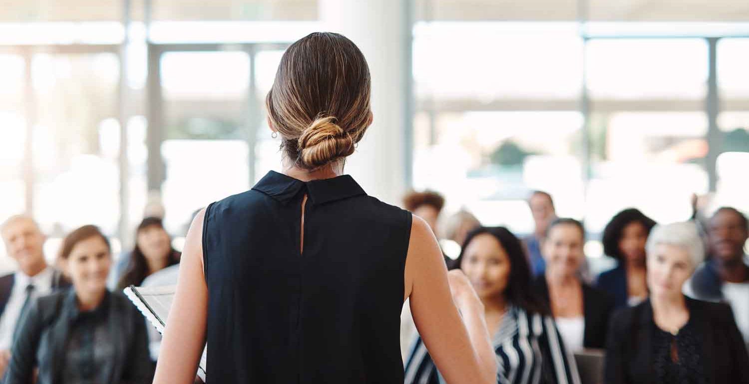 young businesswoman delivering a speech during a conference