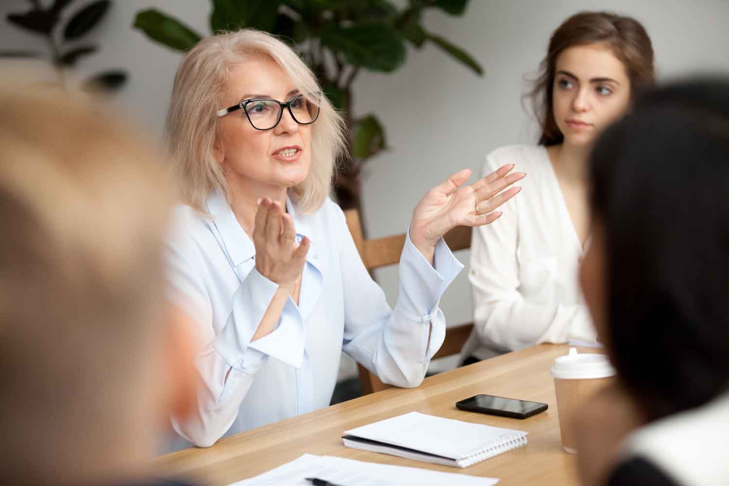 businesswoman speaking to a group of people