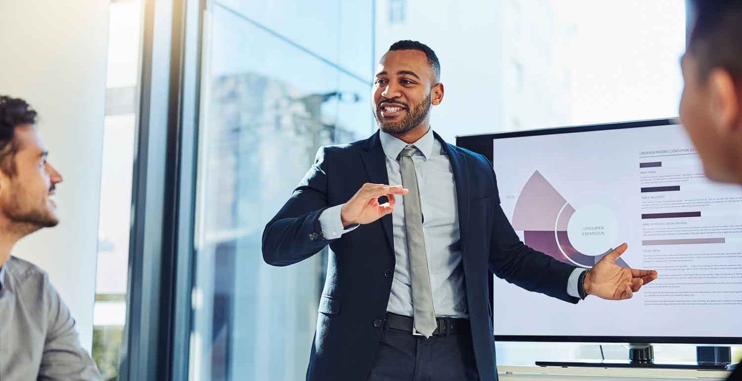 businessman delivering a presentation to his colleagues in the boardroom