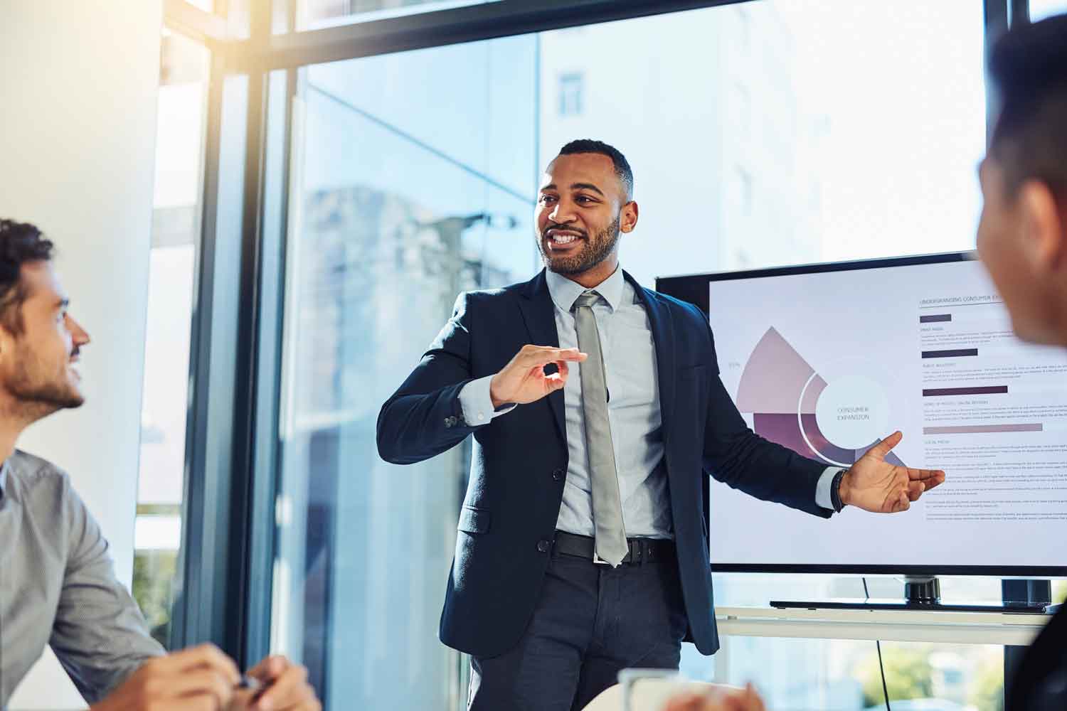 businessman delivering a presentation to his colleagues in the boardroom